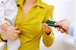 Closeup on doctor's hands giving pills to mother with baby