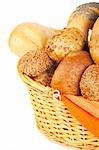 Assortment of baked bread in a basket on white background