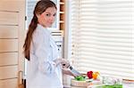 Woman slicing a pepper in her kitchen