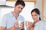 Couple drinking coffee in their kitchen