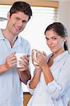 Portrait of a couple drinking tea in their kitchen