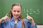 Schoolgirl with the thumbs up in front of a backboard