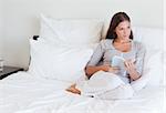 Woman holding a book in her bedroom