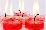 Red and pink candles isolated on grey background.