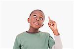 Boy pointing at something above him against a white background