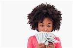 Girl looking at bank notes against a white background