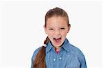 Unhappy girl screaming against a white background