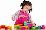 Stock image of little girl playing with construction blocks over white background