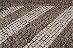 Path paved with small stones. Architectural background of floor.