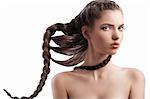 portrait of a pretty long haired brunette with a moving braid hair style on white