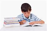 Boy learning his lessons against a white background