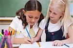 Pupils drawing together in a classroom