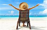 Girl on a tropical beach with hat