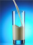 Pouring milk against blue background