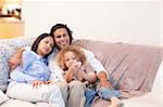 Young family watching television together