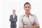 Two businesswomen posing against a white background