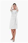 Portrait of a casual businesswoman with the thumbs up against a white background