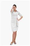 Portrait of a casual businesswoman with the thumb up against a white background