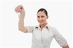 Real estate agent holding keys against a white background