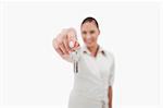 Female real estate agent holding keys with the camera focus on the object