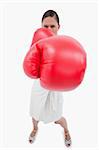 Portrait of an angry boxing businesswoman against a white background