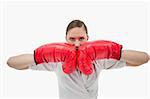 Businesswoman with boxing gloves against a white background