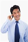 Portrait of a businessman making a phone call against a white background