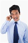 Portrait of a surprised businessman making a phone call against a white background