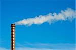 Industrial smoking chimney on blue sky. Thermal Power Plant