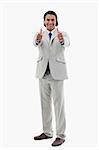 Portrait of a smiling office worker posing with the thumbs up against a white background