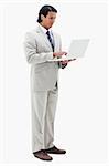 Portrait of a businessman using a notebook against a white background