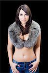 Pretty young brunette in fur. Isolated on black