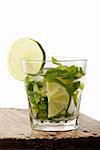 Vertical mojito glass with a slice of lime isolated on white