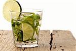 Green mojito with a slice of green lime isolated on white