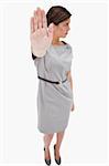 Woman signals stop against a white background