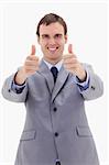 Smiling businessman giving thumbs up against a white background