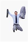 Businessman with suitcase in mid air against a white background