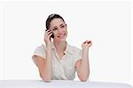 Smiling businesswoman speaking on the phone against a white background