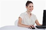 Smiling businesswoman using a monitor against a white background