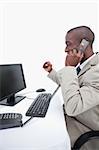 Portrait of a cheerful businessman making a phone call against a white background