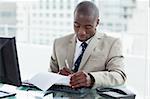 Young entrepreneur signing a document in his office