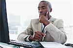 Serious entrepreneur while working with a computer in his office