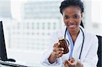 Female doctor giving medication in her office