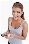 Portrait of a happy woman holding her mobile phone against a white background