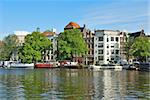 Amsterdam. Beautiful old buildings on the  the river Amstel embankment