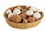 Champignon and portobello mushroom mix in straw basket isolated on white background