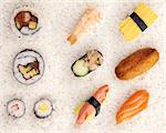 Selection of 10 pieces of sushi shot on a white rice background.