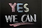 Yes we can - text written in colorful chalk on blackboard
