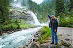 Alps beautiful mountain waterfall Krimml (Austria, Tirol) summer view and woman-tourist near