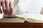 Man turning the page of the Bible. Shallow dof